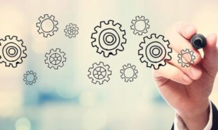 Businessman drawing Gear concept on blurred abstract background